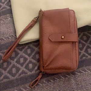 Brown wristlet wallet and has a place for phone.